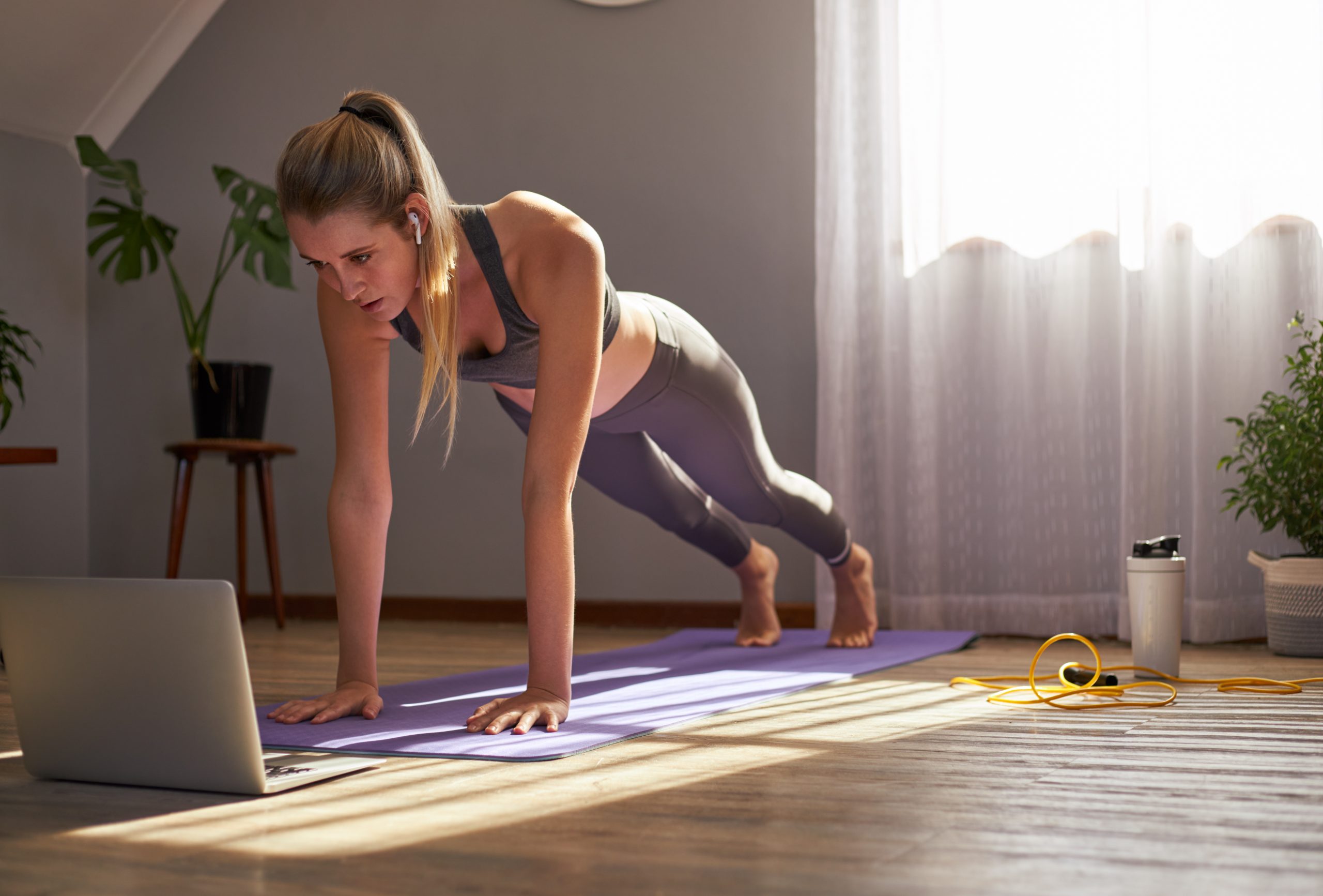 Young woman taking part in online fitness class